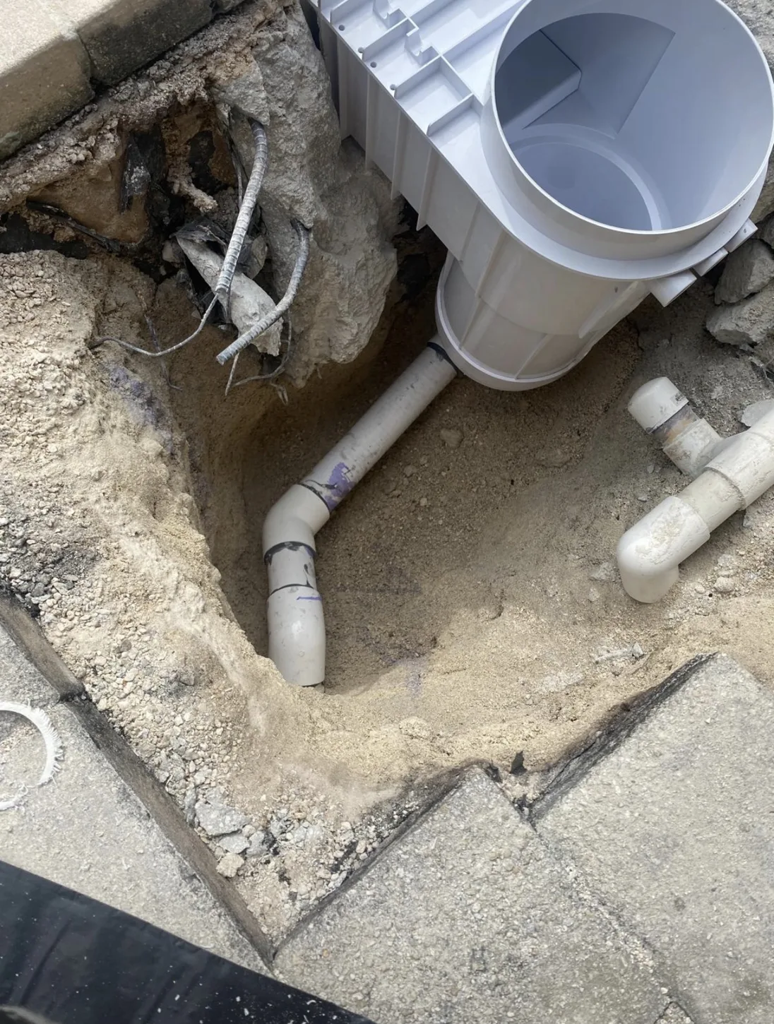 Exposed pool plumbing and skimmer housing
